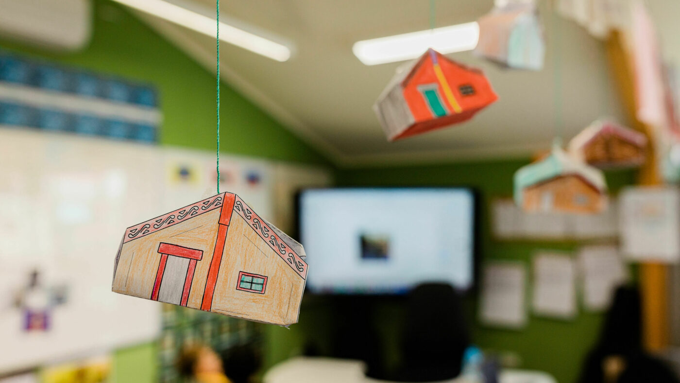 Paper marae suspended from the ceiling by string.