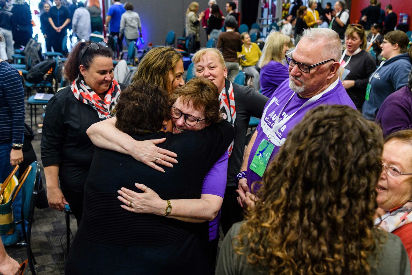 Two members hugging amongst a group at Hui-ā-tau 2022.