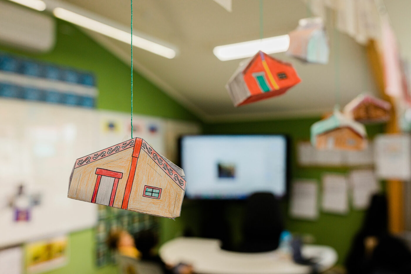 Paper marae suspended from the ceiling by string.