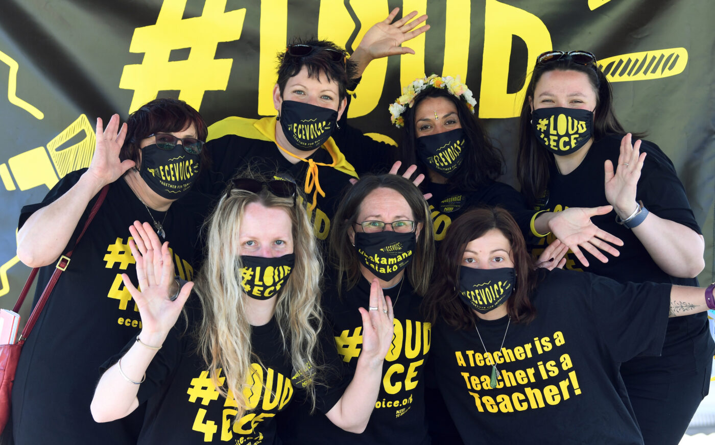 A group of members in #LOUD4ECE t-shirts and facemasks.